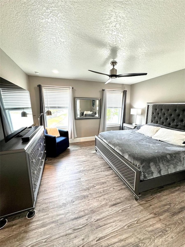 1147 Halapa Way, Trinity, FL 34655 - bedroom with wood finished floors, a textured ceiling, ceiling fan, and baseboards