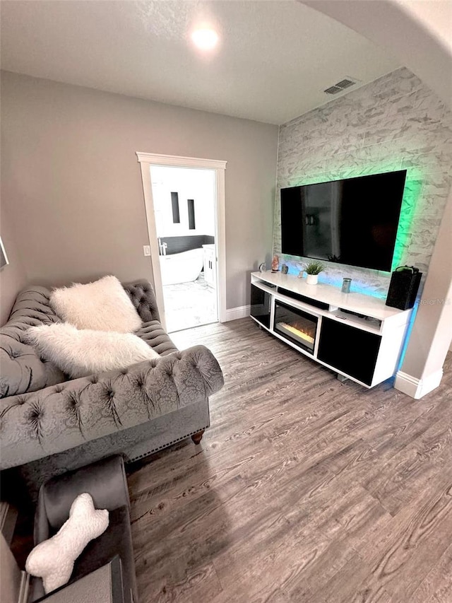 1147 Halapa Way, Trinity, FL 34655 - living room featuring wood finished floors, baseboards, and a fireplace