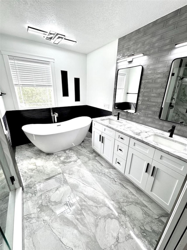 1147 Halapa Way, Trinity, FL 34655 - full bath featuring a shower stall, double vanity, marble finish floors, a textured ceiling, and a freestanding bath