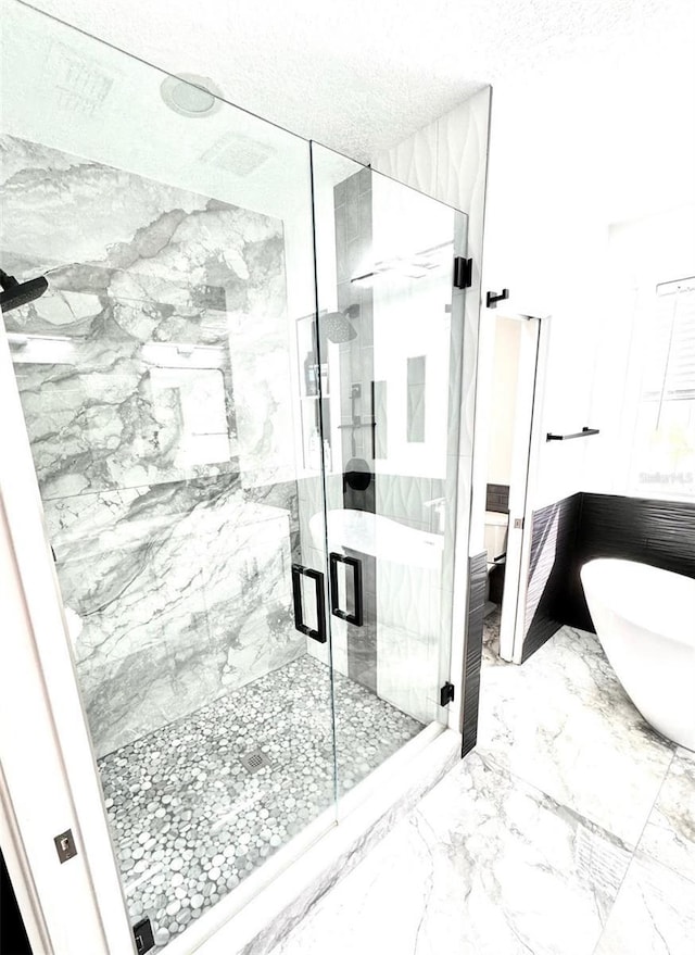 1147 Halapa Way, Trinity, FL 34655 - full bath featuring a marble finish shower, a soaking tub, marble tiled flooring, and a textured ceiling