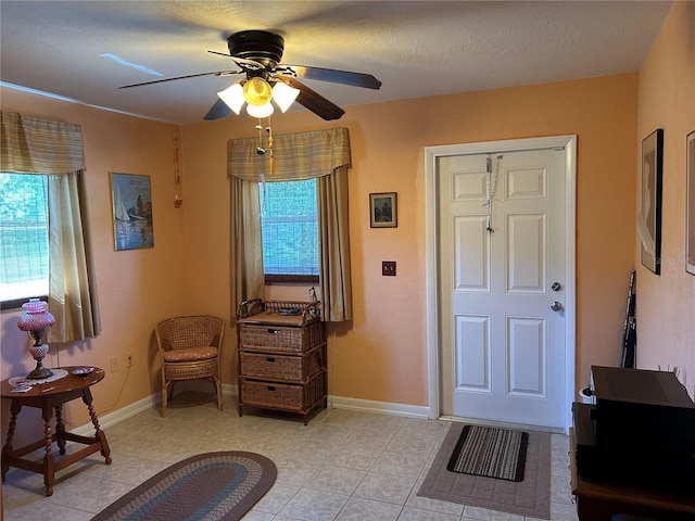 3827 15th Ave N, Saint Petersburg, FL 33713 - foyer entrance featuring healthy amount of natural light, ceiling fan, light tile patterned flooring, and baseboards