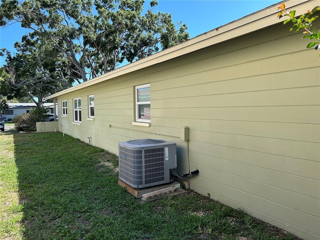 3827 15th Ave N, Saint Petersburg, FL 33713 - view of property exterior with central AC and a lawn