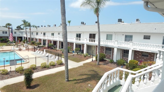 4744 Azalea Dr Unit 203B, New Port Richey, FL 34652 - rear view of property with a community pool and a patio