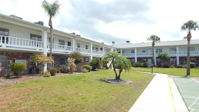 4744 Azalea Dr Unit 203B, New Port Richey, FL 34652 - surrounding community featuring a yard and shuffleboard