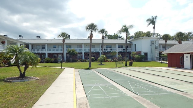 4744 Azalea Dr Unit 203B, New Port Richey, FL 34652 - view of property's community featuring a lawn and shuffleboard