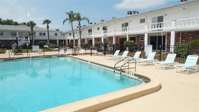 4744 Azalea Dr Unit 203B, New Port Richey, FL 34652 - community pool featuring fence and a patio