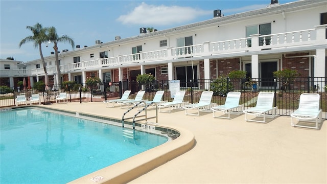4744 Azalea Dr Unit 203B, New Port Richey, FL 34652 - community pool featuring a patio area and fence
