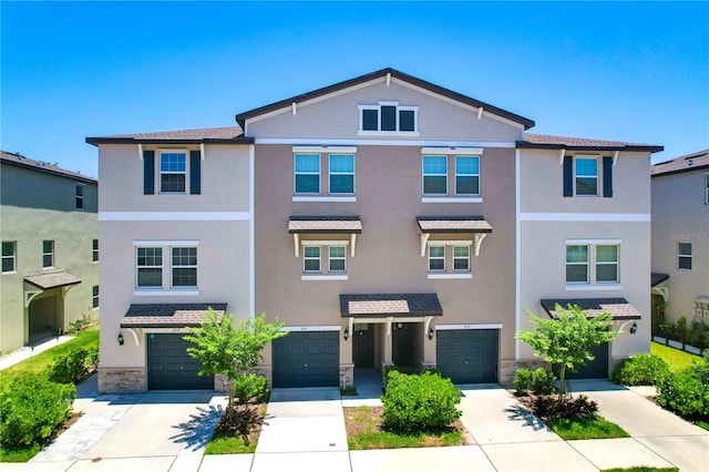 842 Tennyson Mill Cir, Tampa, FL 33619 - multi unit property featuring a garage, driveway, stone siding, and stucco siding