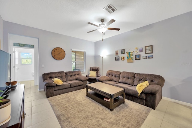 842 Tennyson Mill Cir, Tampa, FL 33619 - living room with light tile patterned floors, a ceiling fan, and plenty of natural light