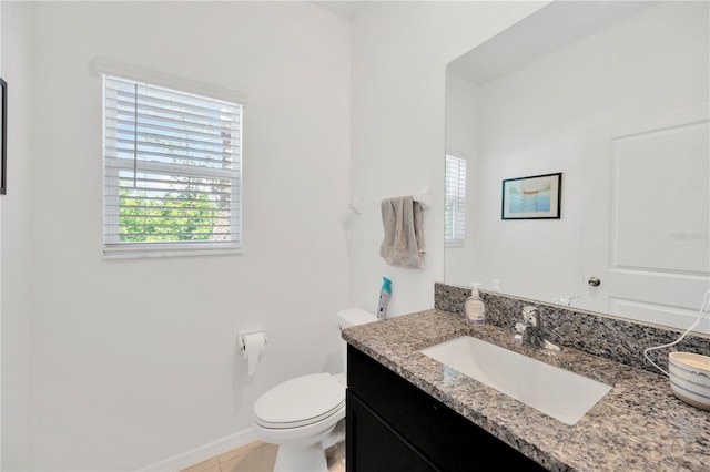 842 Tennyson Mill Cir, Tampa, FL 33619 - bathroom featuring healthy amount of natural light, toilet, vanity, and baseboards