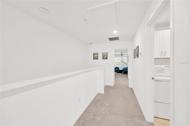 842 Tennyson Mill Cir, Tampa, FL 33619 - hallway with washer / dryer, light colored carpet, an upstairs landing, and baseboards