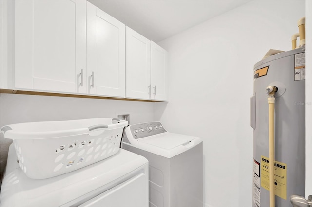 842 Tennyson Mill Cir, Tampa, FL 33619 - laundry area with electric water heater, washer and clothes dryer, and cabinet space