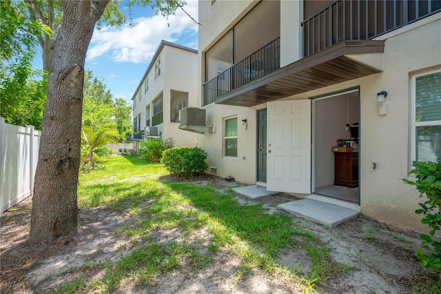842 Tennyson Mill Cir, Tampa, FL 33619 - view of exterior entry with stucco siding, fence, and cooling unit