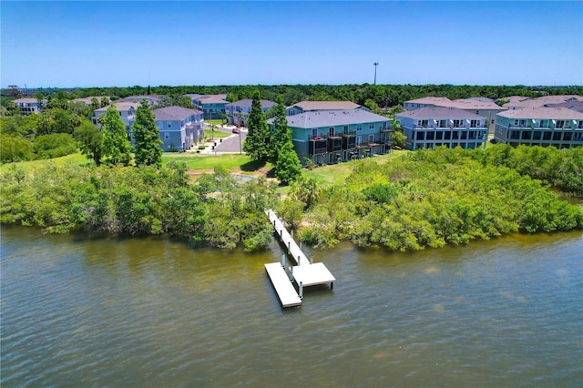 842 Tennyson Mill Cir, Tampa, FL 33619 - aerial view of residential area with a tree filled landscape and a nearby body of water
