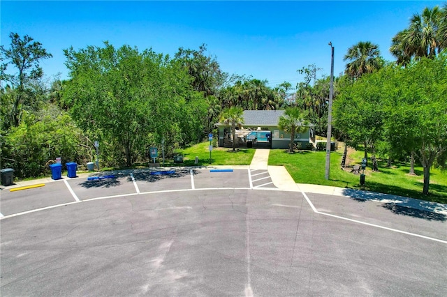 842 Tennyson Mill Cir, Tampa, FL 33619 - uncovered parking lot with view of wooded area