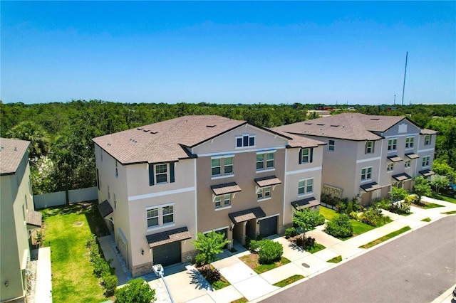 842 Tennyson Mill Cir, Tampa, FL 33619 - view of front of property with a garage, stucco siding, driveway, and fence