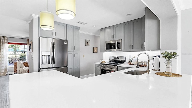 kitchen featuring stainless steel appliances, a sink, gray cabinets, light countertops, and recessed lighting