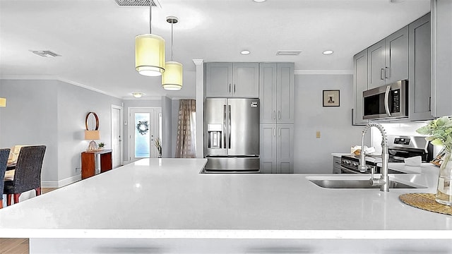 kitchen with stainless steel appliances, gray cabinetry, crown molding, light countertops, and a sink