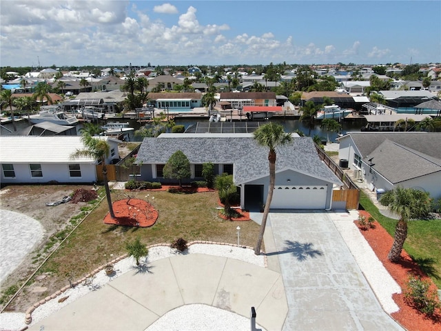 aerial view of residential area featuring a large body of water