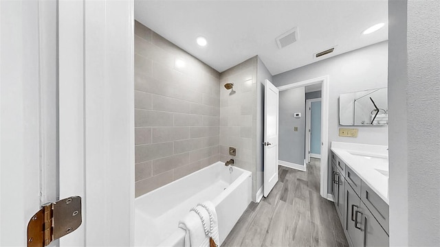 full bathroom featuring  shower combination, vanity, wood finished floors, and baseboards