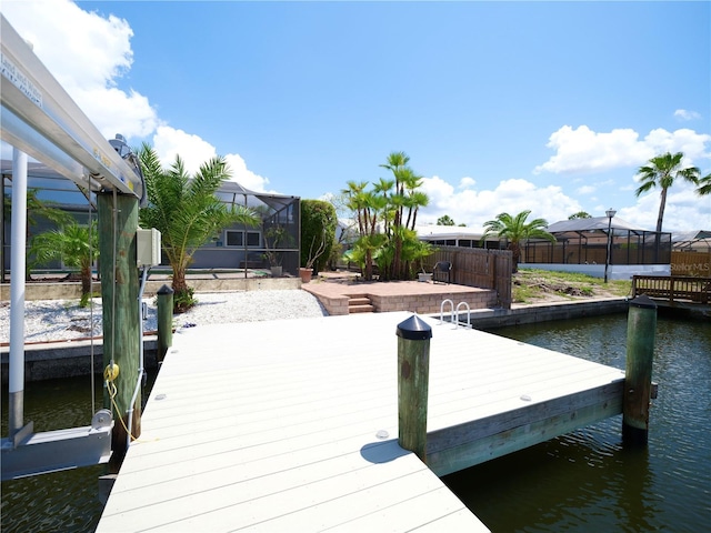dock featuring a water view and glass enclosure