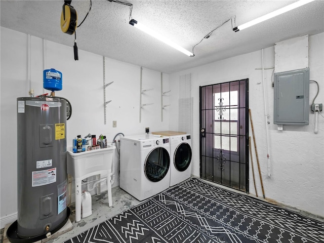 clothes washing area featuring water heater, electric panel, independent washer and dryer, and a textured ceiling