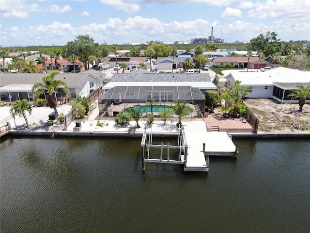 aerial view of residential area featuring a large body of water