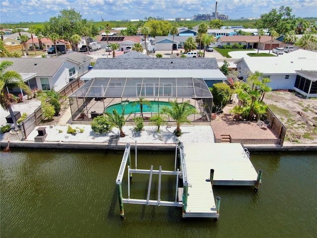 aerial perspective of suburban area with a nearby body of water and a pool
