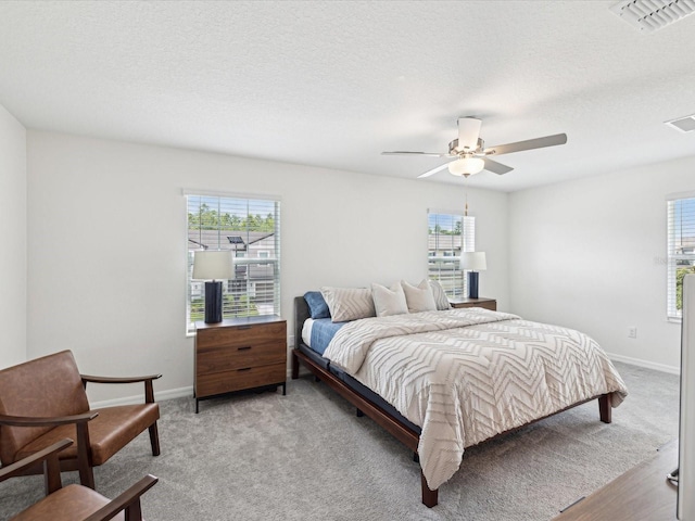 17729 Nectar Flume Dr, Land O Lakes, FL 34638 - bedroom with multiple windows, ceiling fan, baseboards, and a textured ceiling
