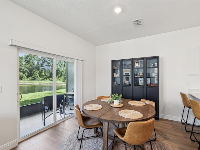 17729 Nectar Flume Dr, Land O Lakes, FL 34638 - dining area featuring wood finished floors, baseboards, and a textured ceiling