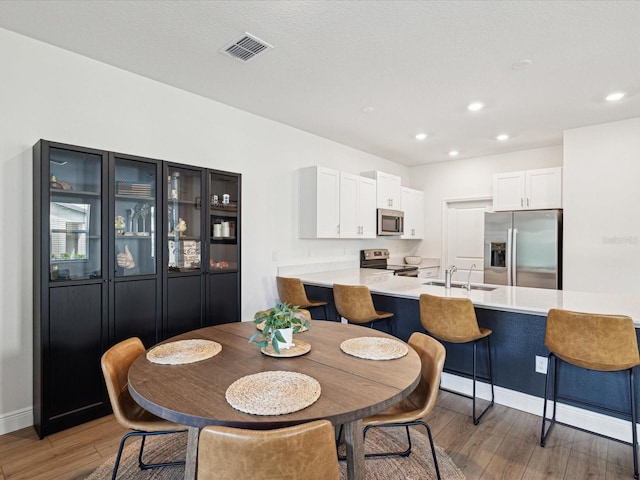 17729 Nectar Flume Dr, Land O Lakes, FL 34638 - dining space featuring light wood-style flooring, baseboards, and recessed lighting