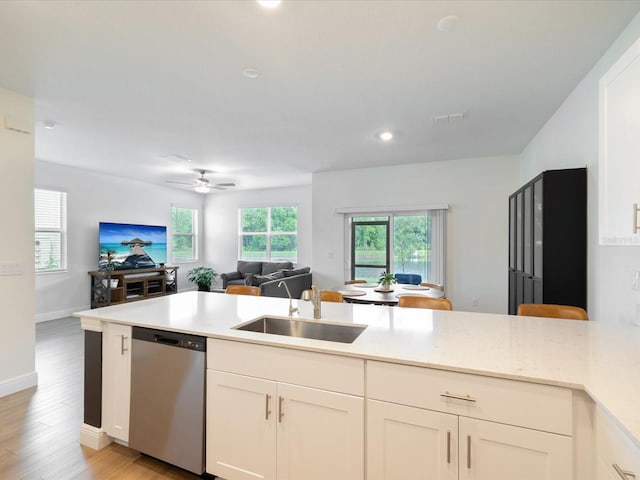 17729 Nectar Flume Dr, Land O Lakes, FL 34638 - kitchen featuring stainless steel dishwasher, a sink, open floor plan, light wood-style floors, and a ceiling fan