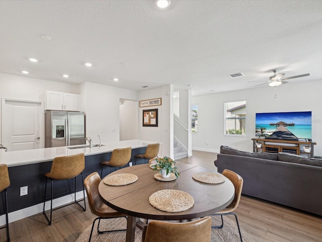 17729 Nectar Flume Dr, Land O Lakes, FL 34638 - dining area with stairs, light wood finished floors, baseboards, recessed lighting, and ceiling fan