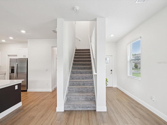 17729 Nectar Flume Dr, Land O Lakes, FL 34638 - stairway featuring wood finished floors, baseboards, and recessed lighting