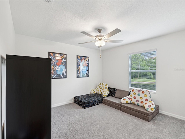 17729 Nectar Flume Dr, Land O Lakes, FL 34638 - living room with carpet flooring, ceiling fan, baseboards, and a textured ceiling