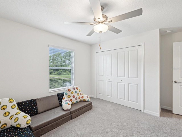 17729 Nectar Flume Dr, Land O Lakes, FL 34638 - living area featuring carpet floors, a textured ceiling, ceiling fan, and baseboards