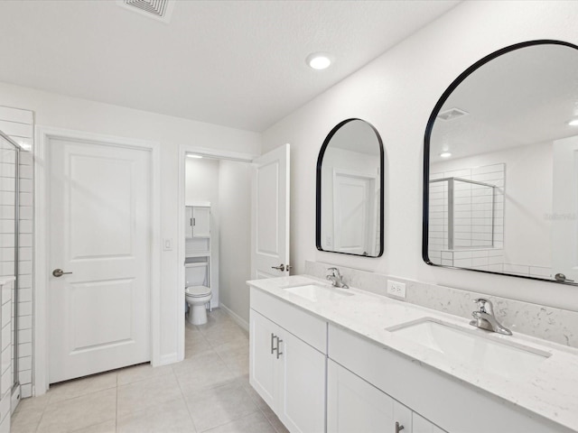 17729 Nectar Flume Dr, Land O Lakes, FL 34638 - full bath with tile patterned flooring, toilet, double vanity, a tile shower, and recessed lighting