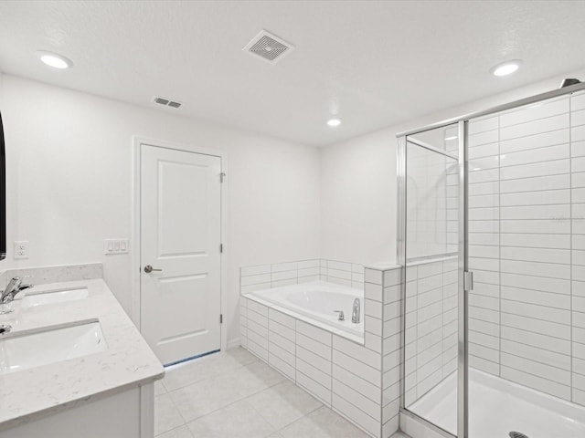 17729 Nectar Flume Dr, Land O Lakes, FL 34638 - bathroom with a stall shower, a garden tub, tile patterned floors, recessed lighting, and double vanity