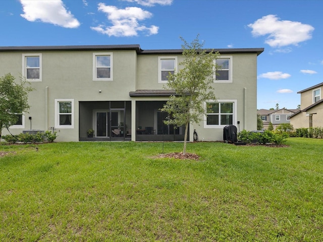 17729 Nectar Flume Dr, Land O Lakes, FL 34638 - rear view of property featuring stucco siding, a sunroom, and a yard