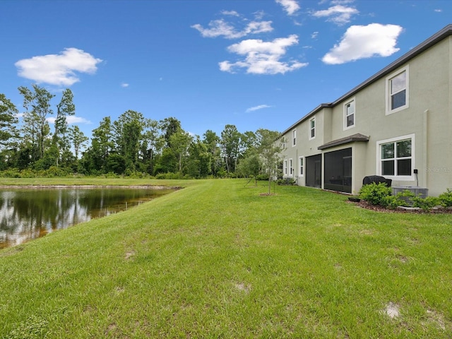 17729 Nectar Flume Dr, Land O Lakes, FL 34638 - view of green lawn featuring a water view and central AC unit