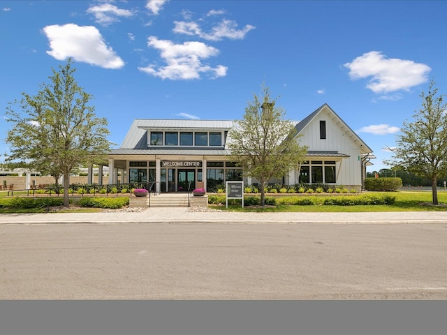 17729 Nectar Flume Dr, Land O Lakes, FL 34638 - view of front of house with a standing seam roof, a porch, metal roof, and board and batten siding