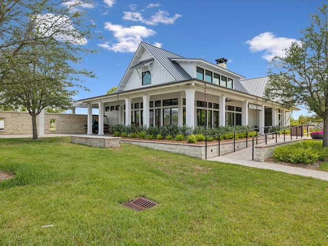 17729 Nectar Flume Dr, Land O Lakes, FL 34638 - back of house with metal roof, board and batten siding, a chimney, and a standing seam roof