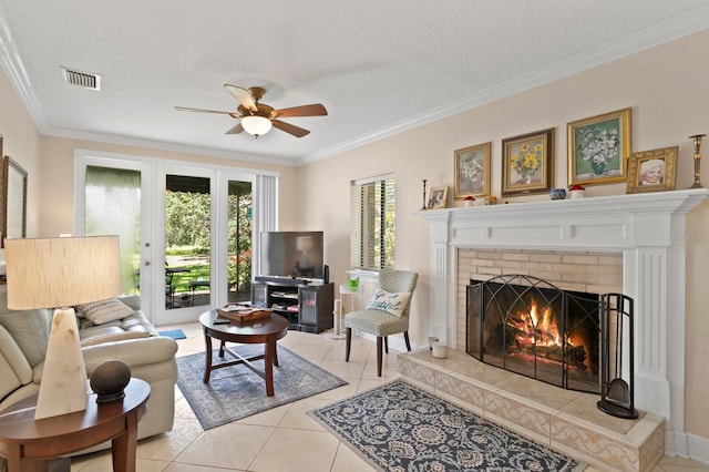 3005 W Sligh Ave, Tampa, FL 33614 - living room featuring ceiling fan, a brick fireplace, ornamental molding, light tile patterned floors, and a textured ceiling