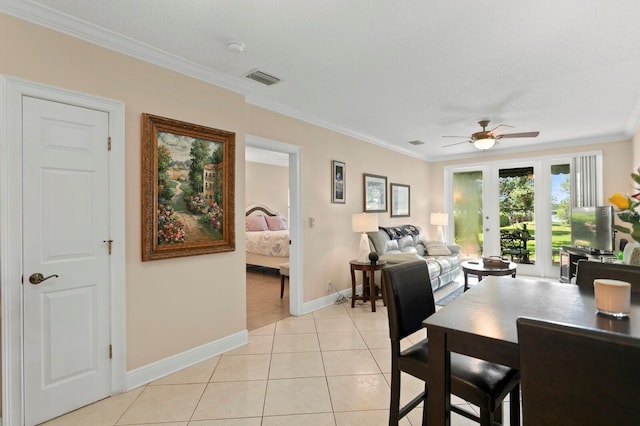 3005 W Sligh Ave, Tampa, FL 33614 - dining area featuring ornamental molding, ceiling fan, baseboards, and light tile patterned floors