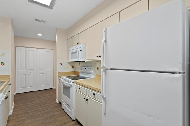 3005 W Sligh Ave, Tampa, FL 33614 - kitchen with white appliances, dark wood-type flooring, light countertops, backsplash, and recessed lighting