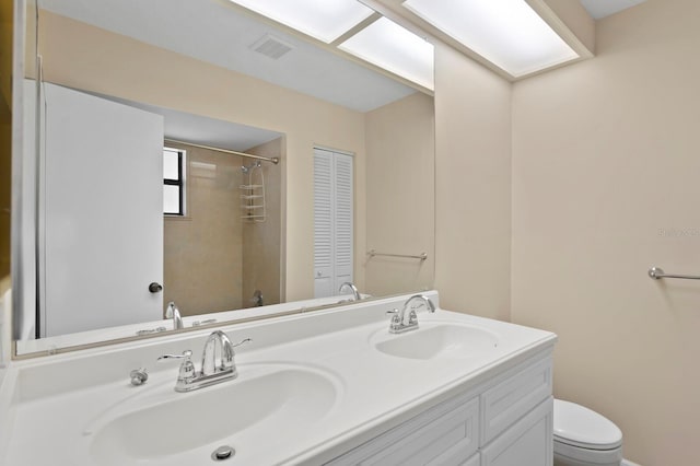 3005 W Sligh Ave, Tampa, FL 33614 - full bathroom with toilet, double vanity, and a shower