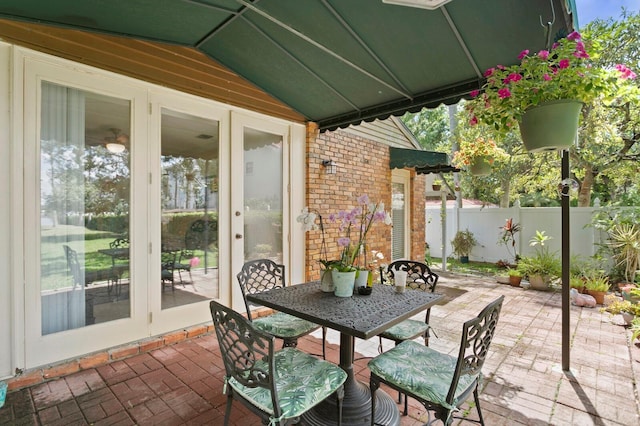 3005 W Sligh Ave, Tampa, FL 33614 - view of patio / terrace featuring fence, outdoor dining space, and french doors