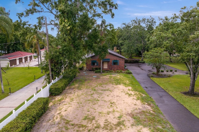 3005 W Sligh Ave, Tampa, FL 33614 - view of front of house with asphalt driveway, a chimney, and brick siding
