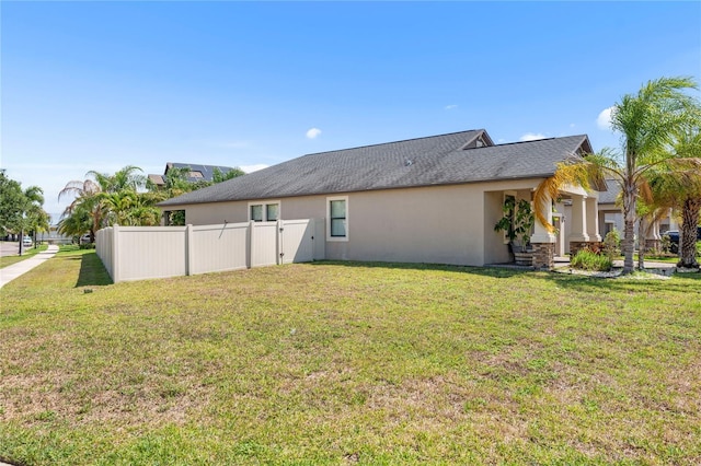 9931 Victory Gallop Loop, Ruskin, FL 33573 - rear view of property featuring stucco siding