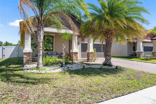 9931 Victory Gallop Loop, Ruskin, FL 33573 - view of front of home featuring a gate, stucco siding, driveway, and a porch